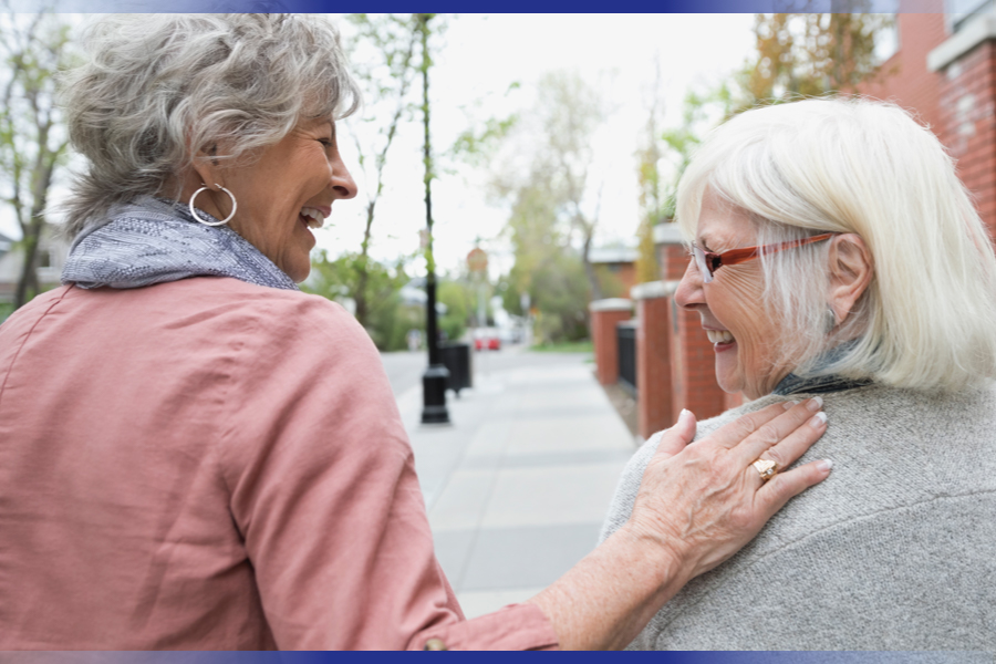 Two elderly women walking together