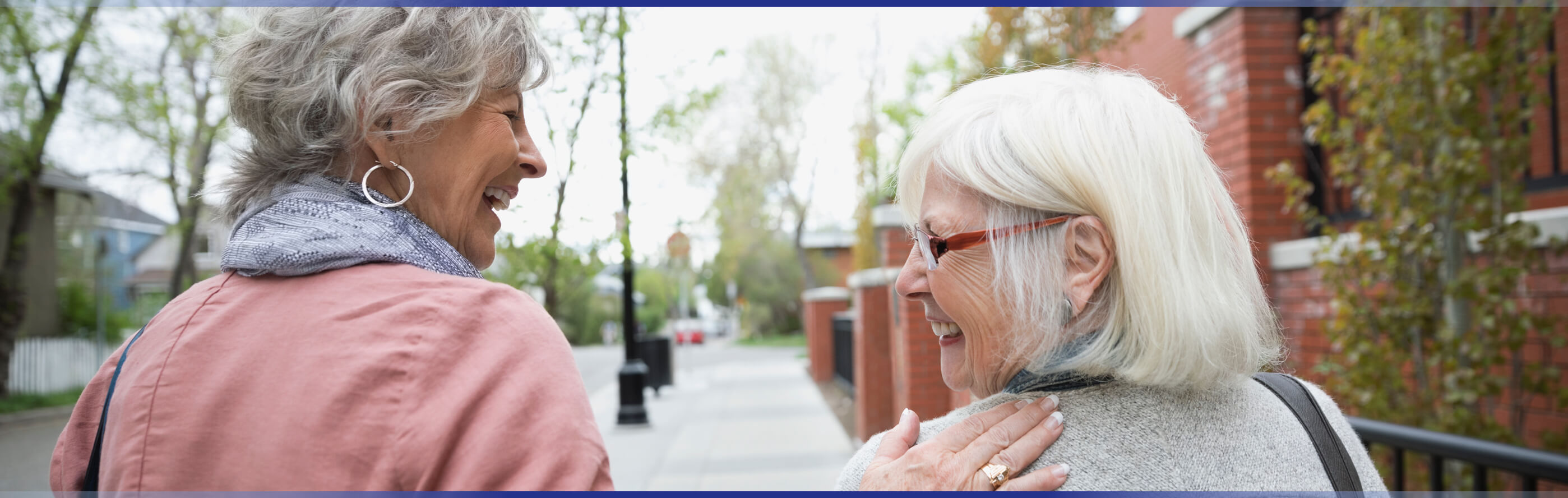 Two elderly women walking together